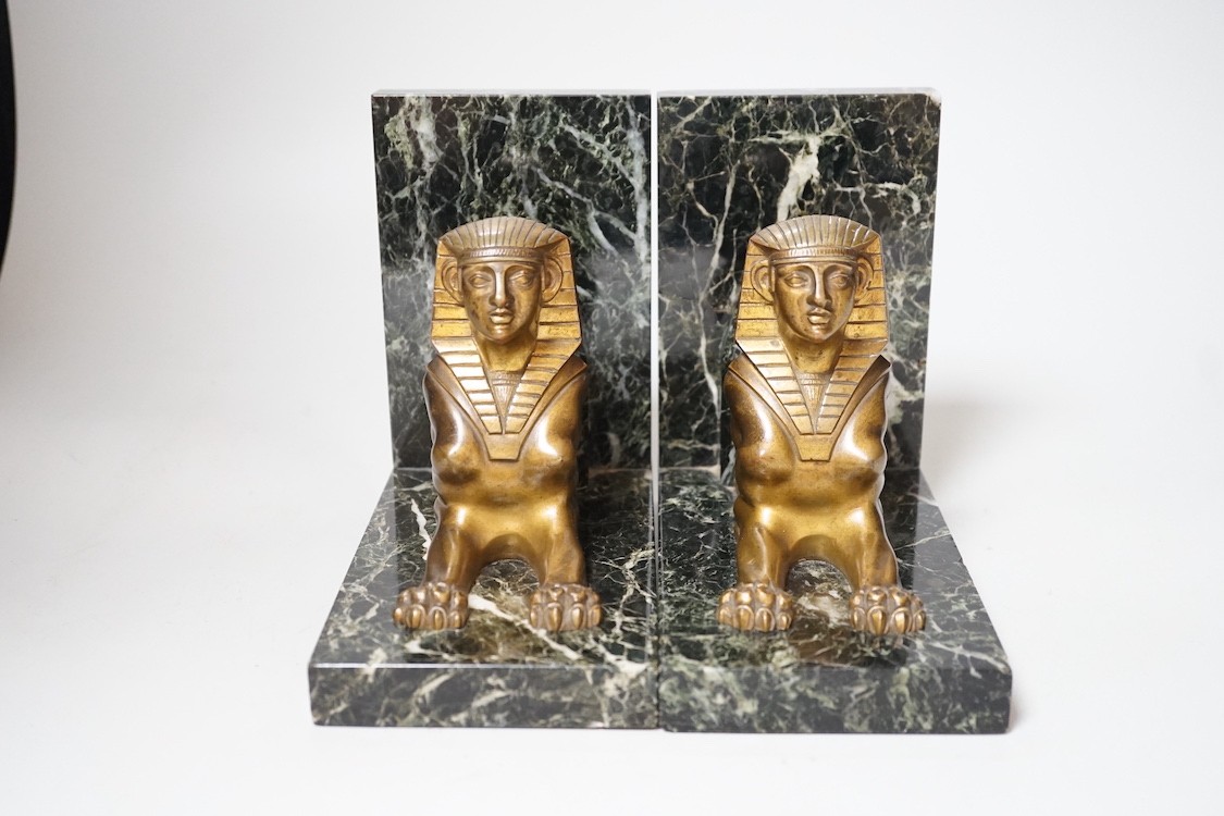 A pair of Art Deco bronze and serpentine 'sphinx' bookends, 17cms wide x 15.5cms high